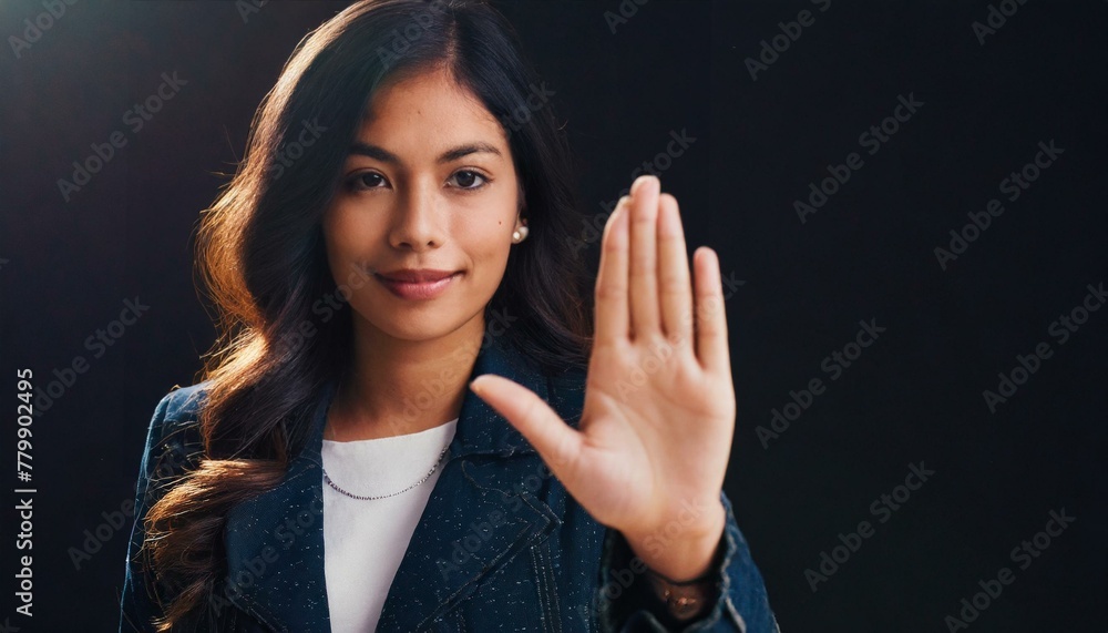 Close up of woman showing stop gesture with hand raising up on black background, young female protesting against domestic violence and abuse, bullying, saying no to gender discrimination Close up of woman showing stop gesture with hand raising up on black background, young female protesting against domestic violence and abuse, bullying, saying no to gender discrimination