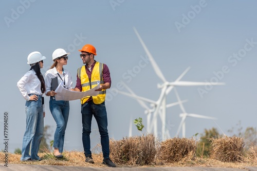 engineer team inspection check control wind power machine construction installation in wind energy factory. technician professional worker discussion check for maintenance electronic wind turbine