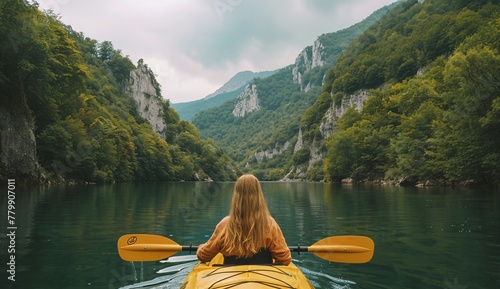 a woman in a kayak on a lake photo
