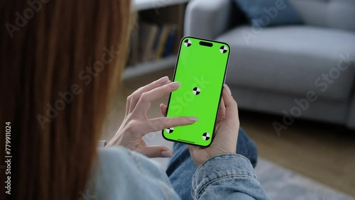 Wallpaper Mural Woman using smartphone vertical green screen. Female holding in hand portable gadget. Tracking markers. Indoors. Browsing social network, news. Watching content video blog. Tap on screen 4K Torontodigital.ca