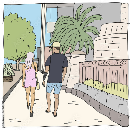 Woman in pink jumpsuit, man in black t-shirt and denim shorts walking on footpath past buildings