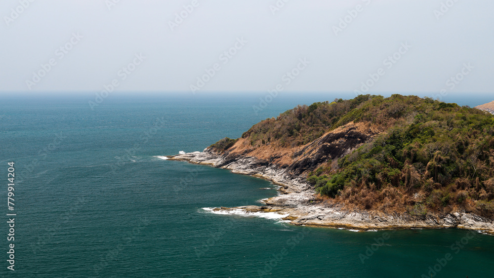 Image of a landscape in Phuket, Thailand near Promthep Cape, a beautiful seaside rock formation and blue waters. Image of a landscape in Phuket, Thailand near Promthep Cape, a beautiful seaside rock formation and blue waters.