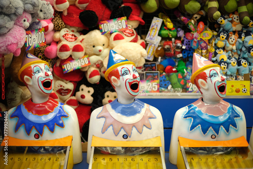 Laughing clowns game at fairground booth