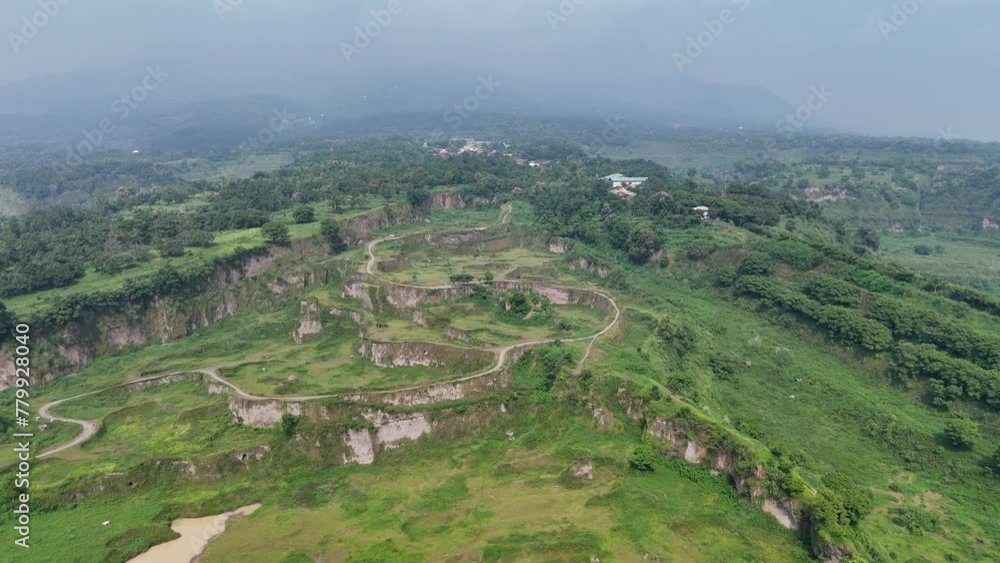 Aerial view of Dieng Valley, Gempol Pasuruan Abandoned mine, used as an artificial natural tourist attraction popular for photos and green grass with panoramic views of Mount Penanggungan Indonesia. Aerial view of Dieng Valley, Gempol Pasuruan Abandoned mine, used as an artificial natural tourist attraction popular for photos and green grass with panoramic views of Mount Penanggungan Indonesia.