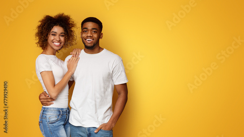 Happy african american couple embracing and smiling