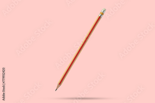 Orange pencil isolated on pink background close up