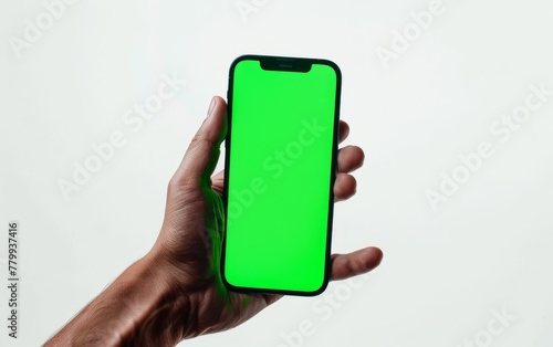 Green screen mobile phone in male hand white background