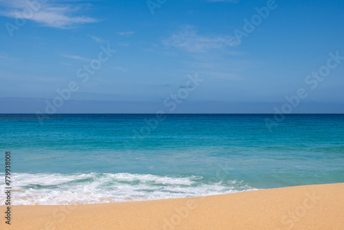 Landscape view of sand and ocean, and blue sky photo