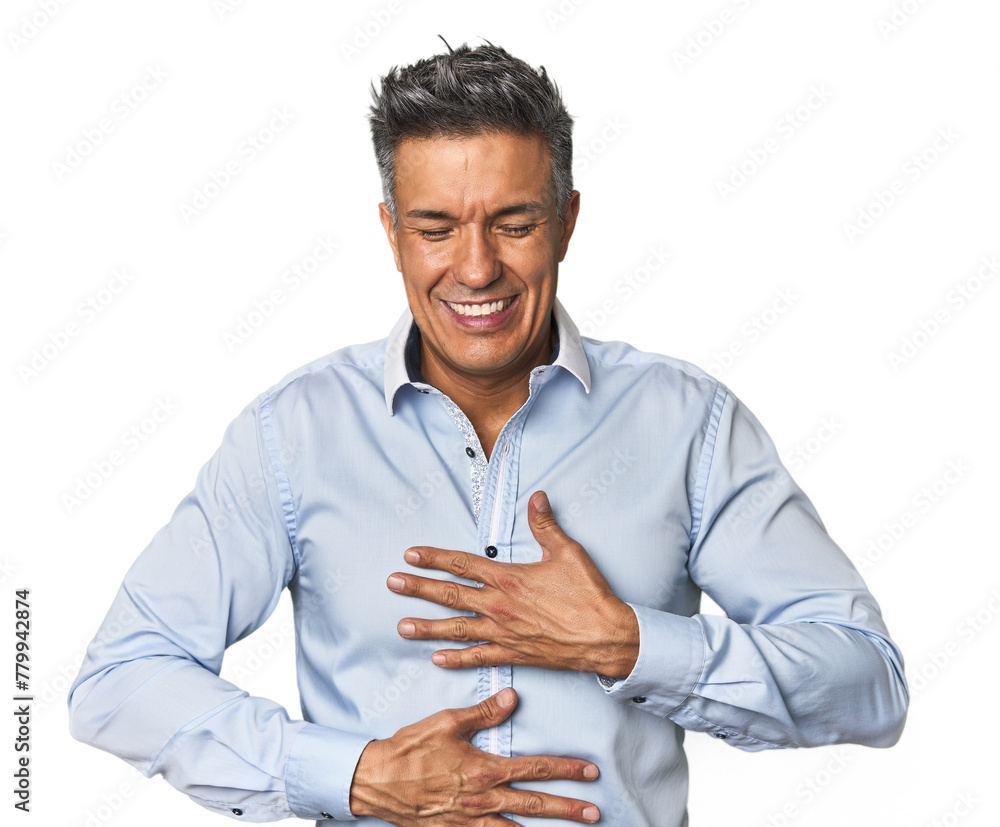 Middle-aged Latino man laughs happily and has fun keeping hands on stomach. Middle-aged Latino man laughs happily and has fun keeping hands on stomach.