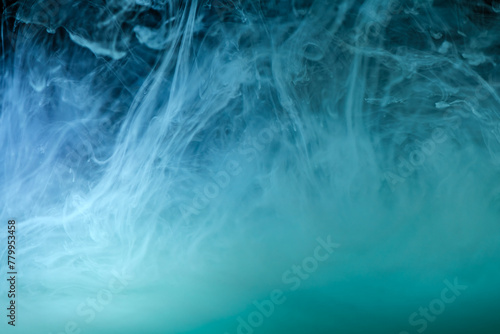 clouds of blue smoke on a black background  clouds of paint in water  aquarium  abstract background  texture