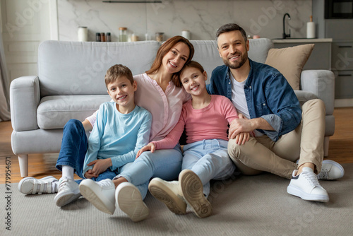 Happy family sitting on the living room sofa photo