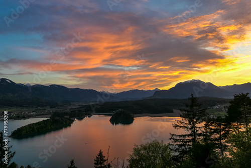 Wallpaper Mural Panoramic sunset view on Lake Faak from Taborhoehe in Carinthia, Austria, Europe. Surrounded by high Austrian Alps mountains. Water surface reflecting soft sunlight. Remote alpine landscape in summer Torontodigital.ca