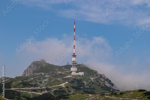 Hiking trail leading to mountain peak Dobratsch, Villacher Alps, Carinthia, Austria, Europe. Alpine meadow along the way to the radio tower on top. Panoramic view of hills and mountains. Wanderlust © Chris