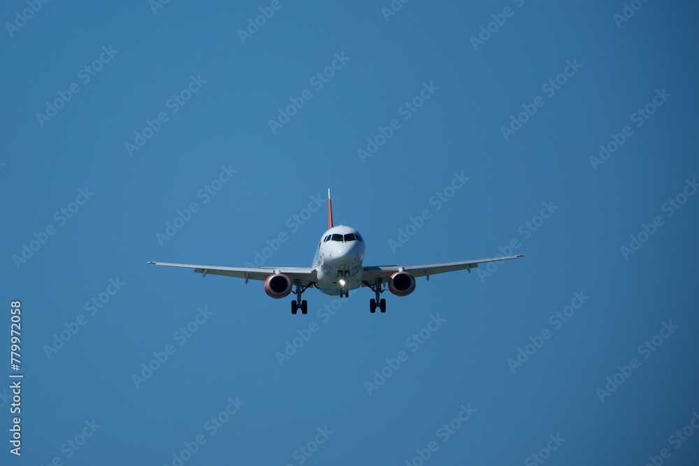 Airplane landing at the airport on a sunny day Airplane landing at the airport on a sunny day