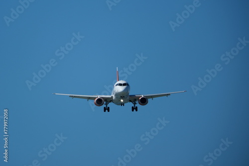 Airplane landing at the airport on a sunny day