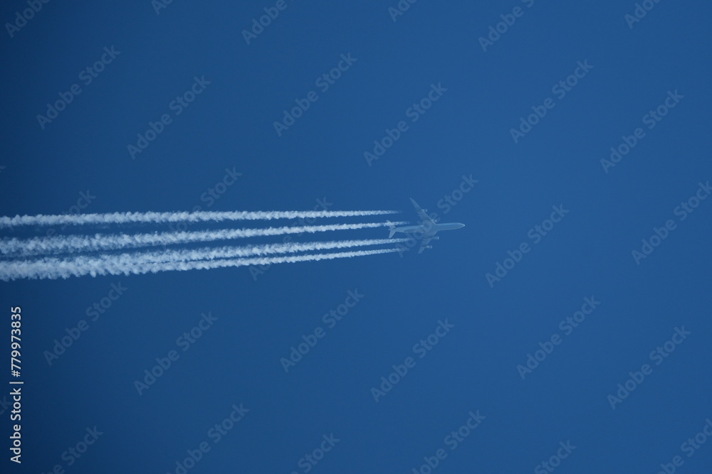 Airplane in the blue sky with contrails. Airplane in the blue sky with contrails.