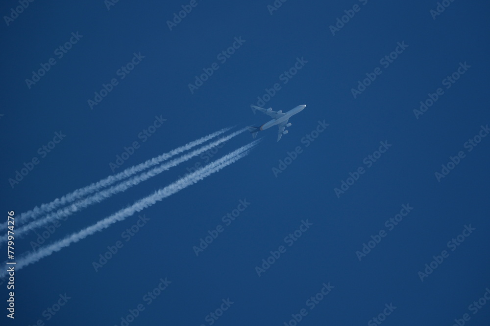 Airplane in the blue sky with contrails. Airplane in the blue sky with contrails.