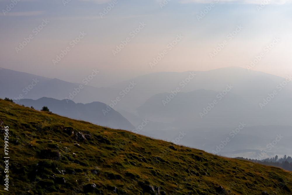 Scenic view from summit Dobratsch on Julian Alps and Karawanks mountain ranges in Carinthia, Austria, Europe. Jagged sharp peaks in Austrian Alps. Wanderlust tranquil atmosphere in alpine wilderness