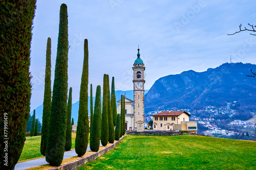 The scenic alley with cypress trees leads to Sant'Abbondio Chuch, Collina d'Oro, Switzerland