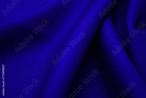 Blue fabric closeup. Plexus threads. Clothing industry. Abstract background. Textile waves.