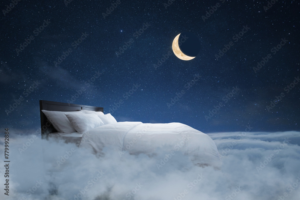 Naklejka premium Bed with pillows and a blanket flies in the clouds with a night starry sky with the moon, creative idea. Sweet dream, concept. Night rest