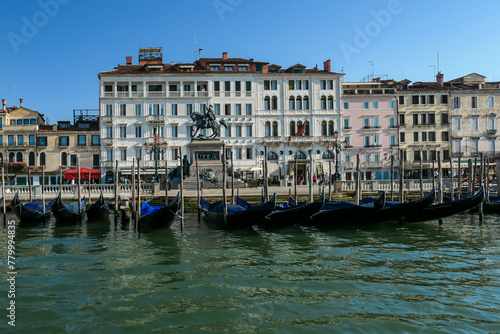 Gondolas parked in front of Londra Palace Venezia near San Marco square  Venice  Veneto  Northern Italy  Europe. Massive statue landmark in front of the building. Discover the Venetian Lagoon