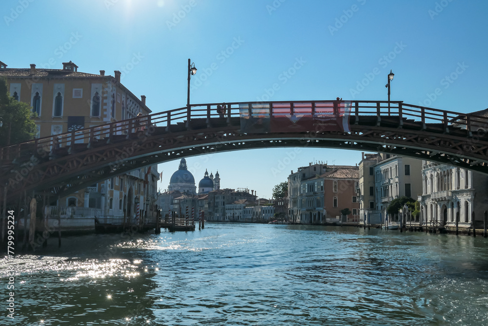 Naklejka premium Panoramic view of the Grand Canal in city of Venice, Veneto, Italy, Europe. Famous landmark cathedral San Simeon Piccolo along and bridge Ponte dell'Accademia. Urban tourism in summer