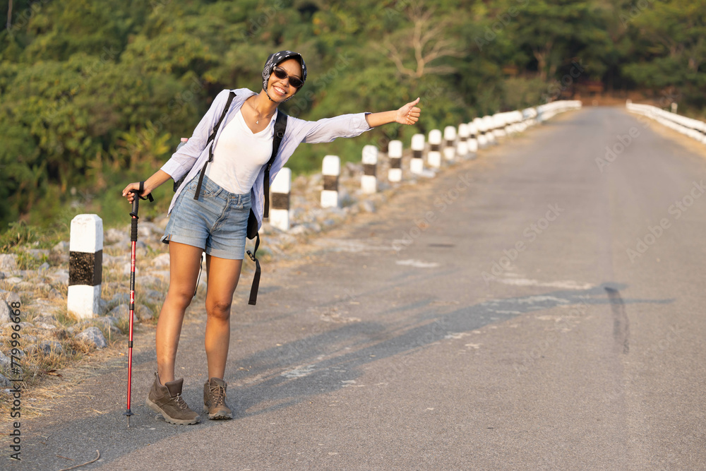 Traveller hitchhiking for the ride during trip Traveller hitchhiking for the ride during trip