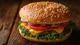   A cheeseburger with tomatoes, lettuce, onions, and sesame seeds on a wooden table
