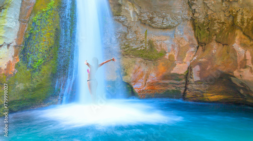 A beautiful woman wearing a bikini bathes in a waterfall - Natural pools with blue water in a rocky Sapadere waterfall and canyon - Alanya, Turkey © muratart