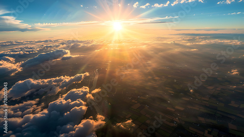 A breathtaking aerial view captured from a plane flying high above the earth, with majestic clouds swirling below and the sun casting golden rays across the horizon #780010843