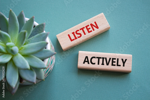 Listen actively symbol. Wooden blocks with words Listen actively. Beautiful grey green background with succulent plant. Business and Active listening concept. Copy space.