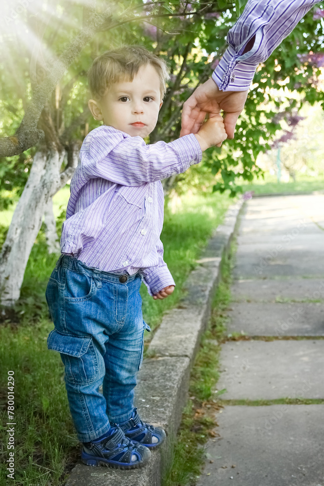 the parent holding the child's hand with a happy background
