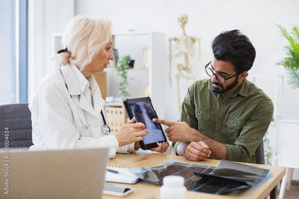 Doctor Developing Family doctor examining diagnostic test results while developing ...