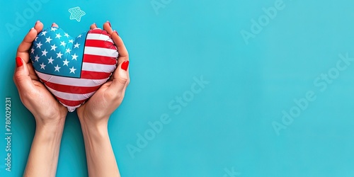 A pair of hands holding an American flag heart-shaped balloon, rising against a clear blue backdrop photo