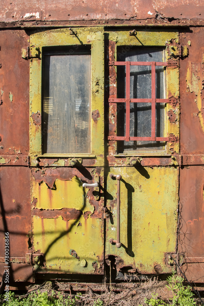 Rusty and peeling paint wall of abandoned neglected railroad car closeup as colorful grunge background Rusty and peeling paint wall of abandoned neglected railroad car closeup as colorful grunge background