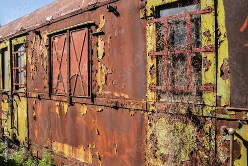 Rusty and peeling paint wall of abandoned neglected railroad car closeup as colorful grunge background