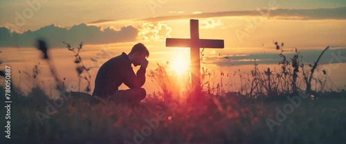 Christian man praying in front of the cross
