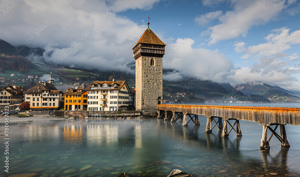 Kapellbrücke over water with a tower and buildings in the background