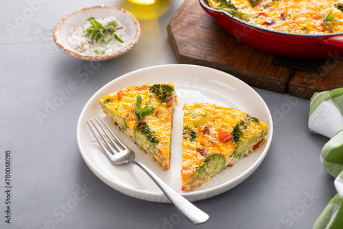 Healthy frittata or quiche with broccoli and red pepper, two slices on plate © fahrwasser