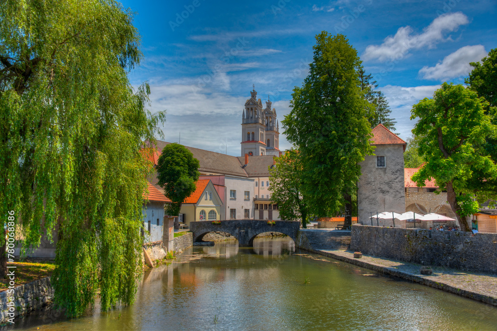 Naklejka premium Bistrica river and the Saint Stephen parish church in Slovenian town Ribnica