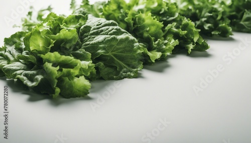 Fresh, vibrant leafy greens arranged in a row evoke a natural, healthy ambiance against a white background.