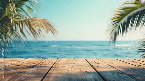 Wooden table top with green palm leaves on sea background
