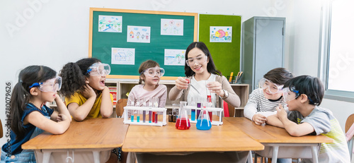 Diversity children student doing a chemical experiment in laboratory at school. Portrait of happy kids at elementary school learn science chemistry with asian teacher. Fun study back to school banner