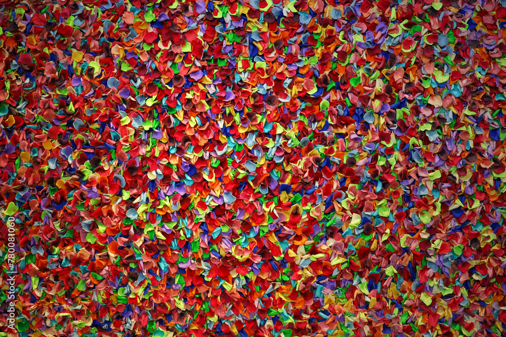 Background material close-up on a wall decorated with colorful flower petals