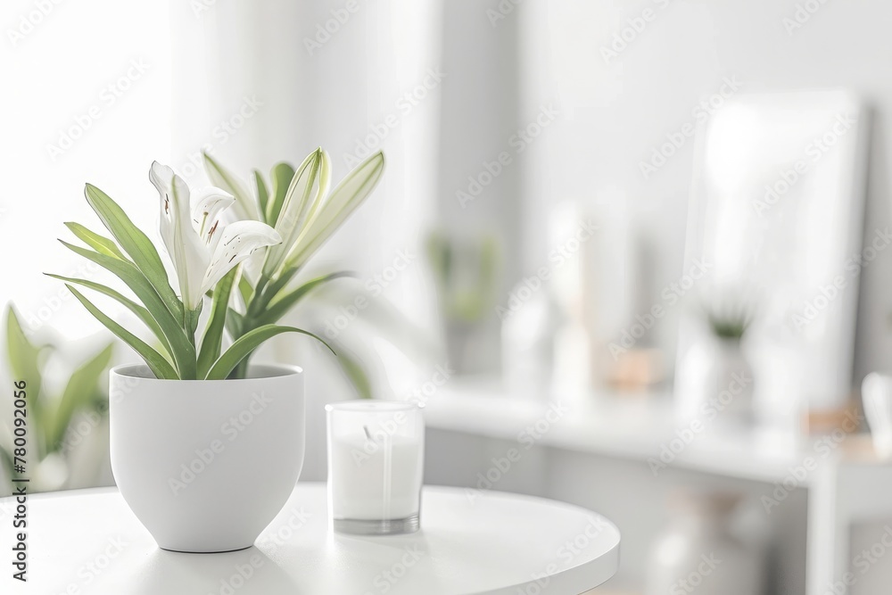 Fresh flowers in white vase placed on small table in bright room interior with paintings, potted plants and candles on shelves in blurred background Fresh flowers in white vase placed on small table in bright room interior with paintings, potted plants and candles on shelves in blurred background