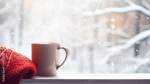 Winter holidays  calm and cosy home  cup of tea or coffee mug and knitted blanket near window in the English countryside cottage  holiday atmosphere