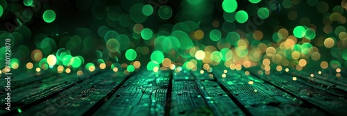 Green lights on a table with a dark background with a bokeh effect. Green light glowing in the air on a wooden floor. Green abstract bokeh effect