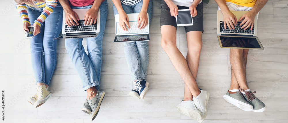 © Pixel-Shot - Students with modern devices studying online indoors