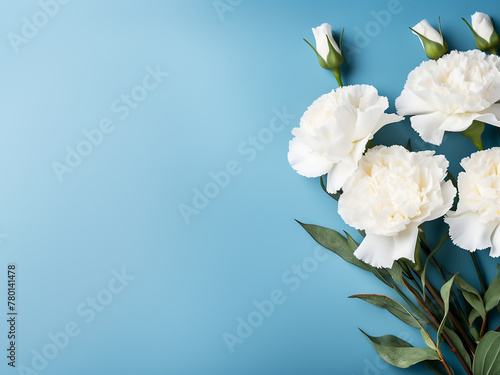 Blue background serves as the canvas for white carnations and eucalyptus on a romantic card